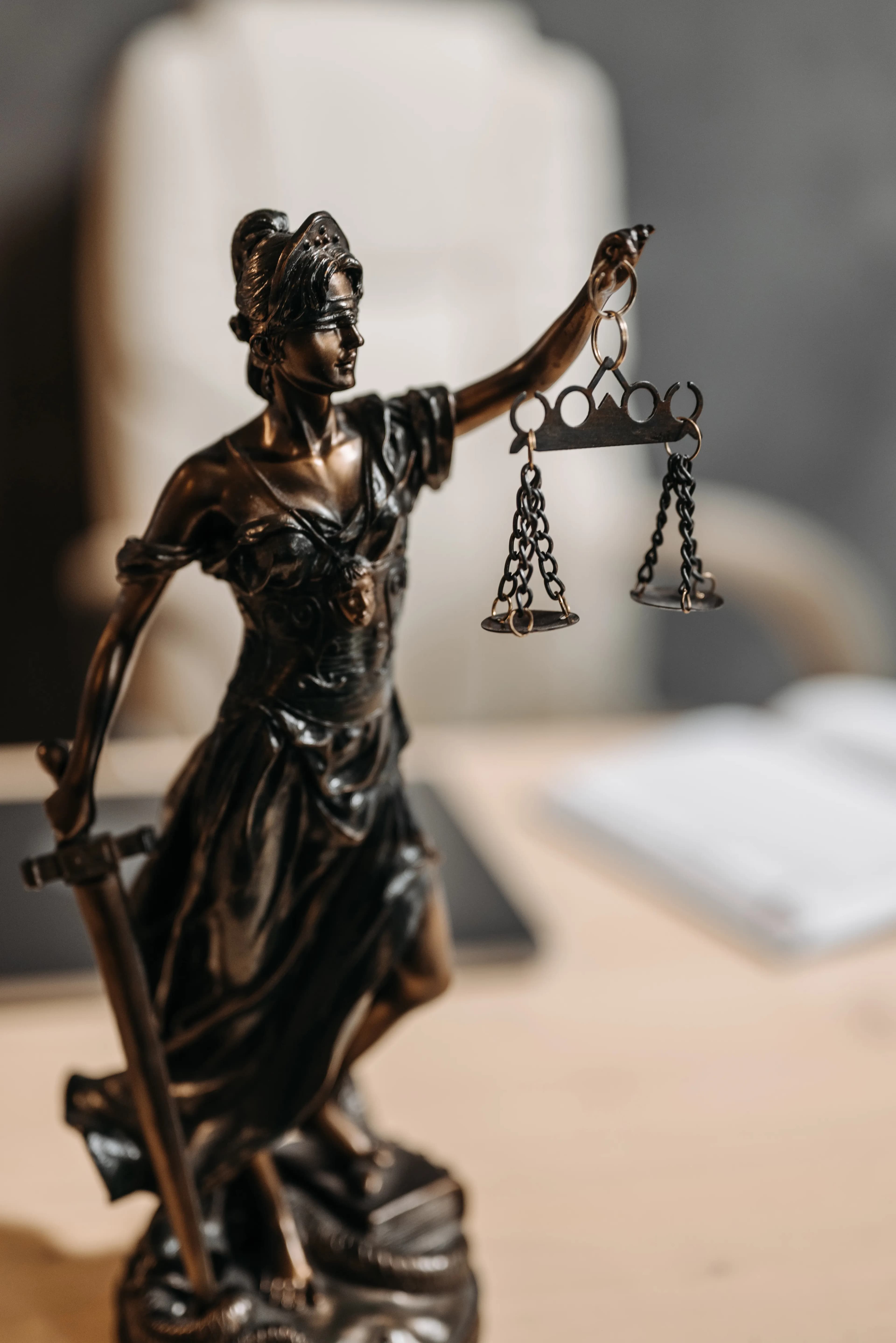 Bronze Lady Justice statue holding the scales, a symbol of justice and fairness